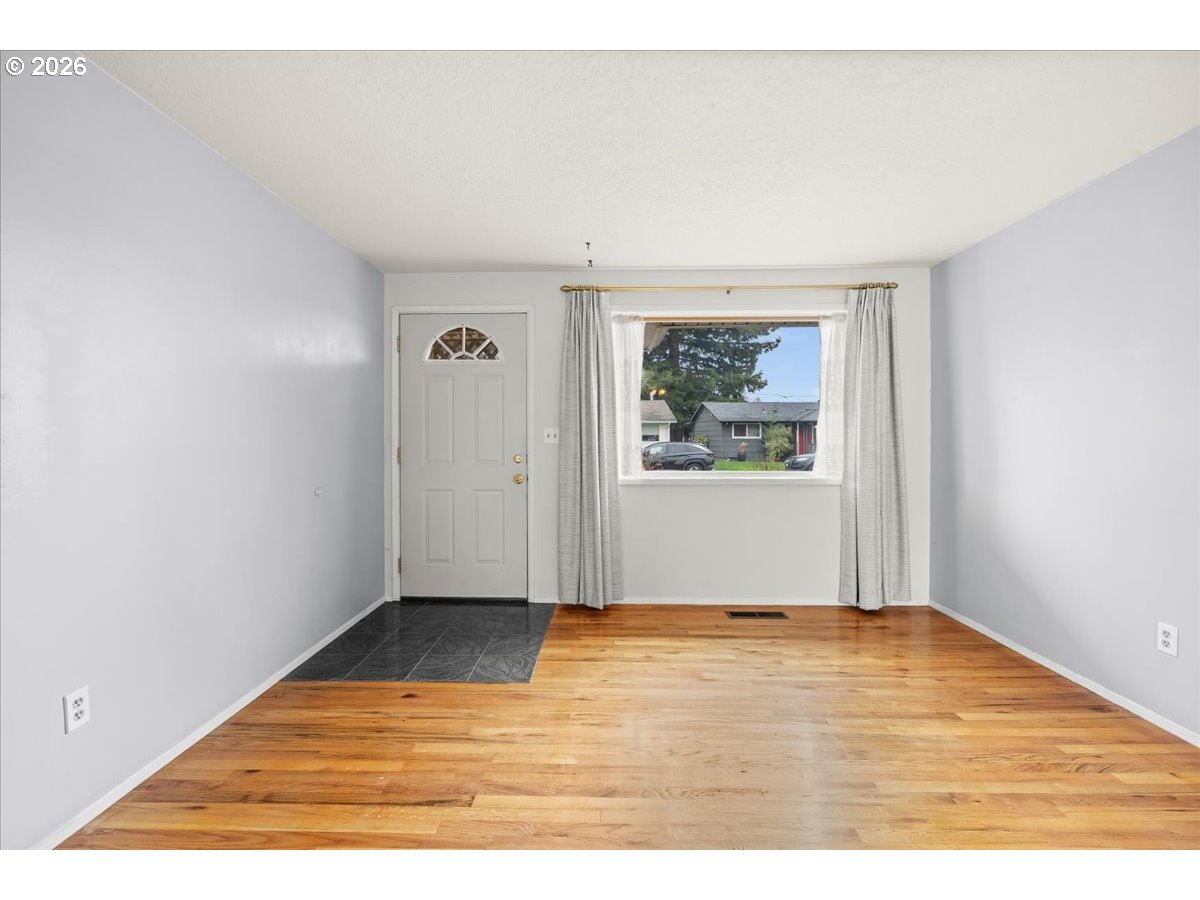 1386 Umpqua Road Woodburn, OR 97071 - Photo 6 of 32 a view of an empty room with wooden floor