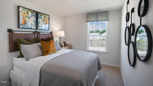 a bed sitting in a bedroom next to a window