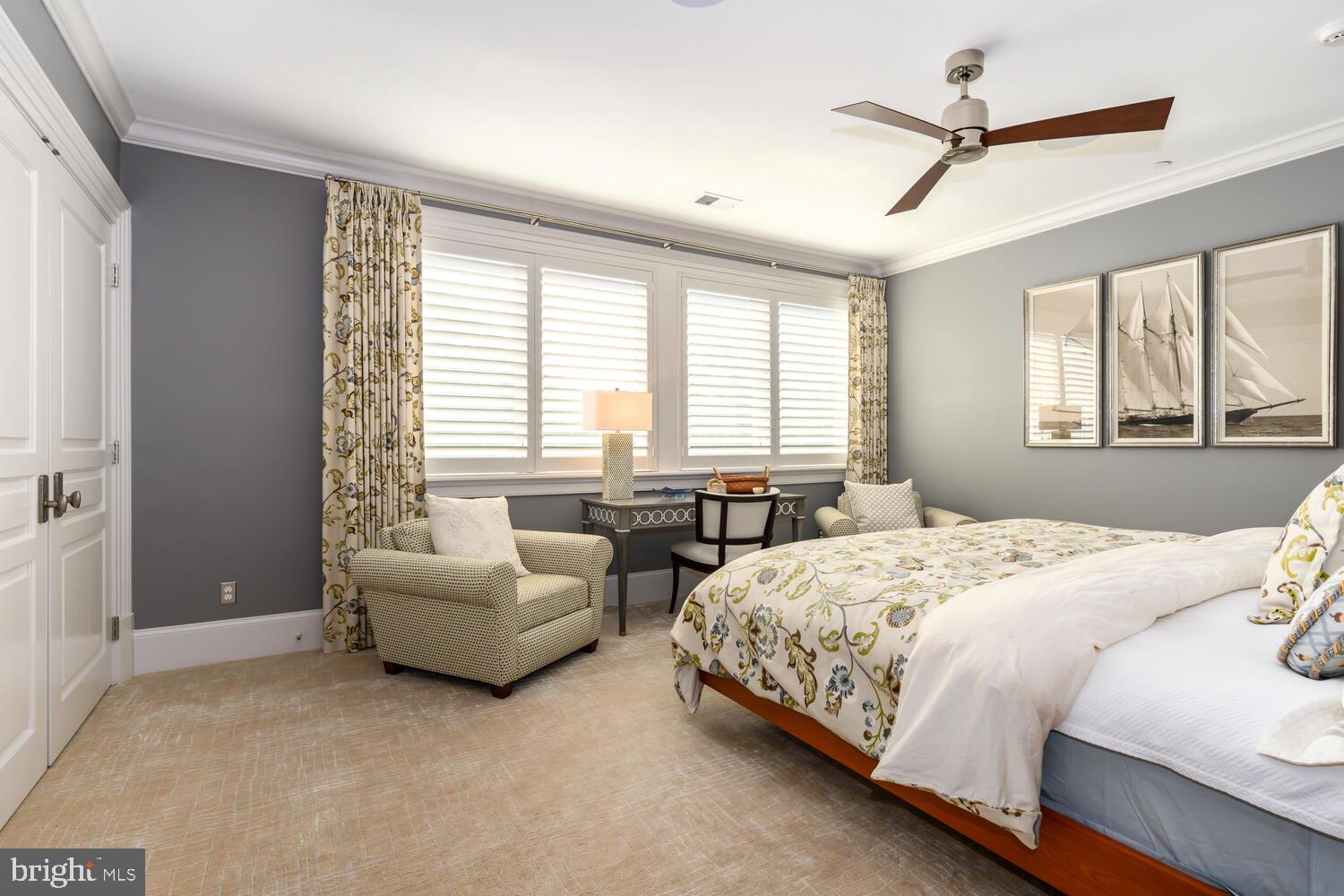 7508 Cooper Point Road Bozman, MD 21612 - Photo 96 of 116 a bedroom with a bed a couch and a ceiling fan