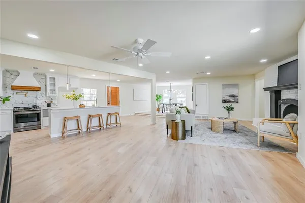 a living room with fireplace furniture and a wooden floor