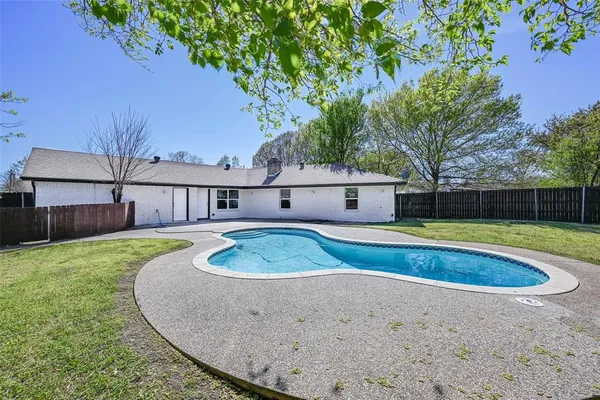 a view of a swimming pool with a backyard