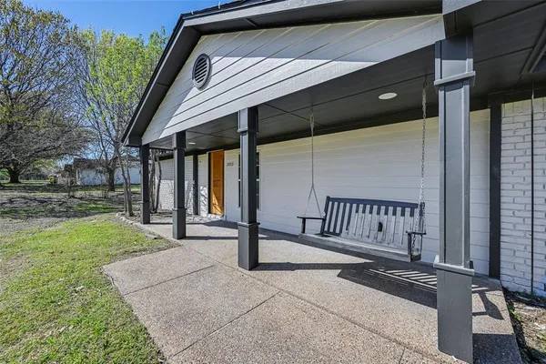 a view of backyard with a deck and garden