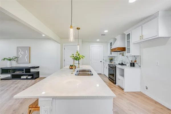 a kitchen with granite countertop a white cabinets and appliances