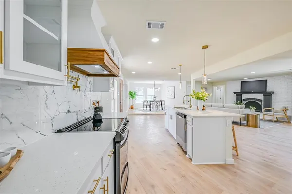 a kitchen with a sink a counter top space and stainless steel appliances