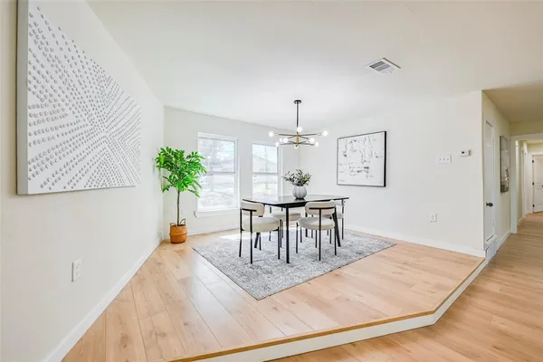 a view of a dining room with furniture and a chandelier