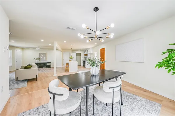 a dining room with furniture and a chandelier
