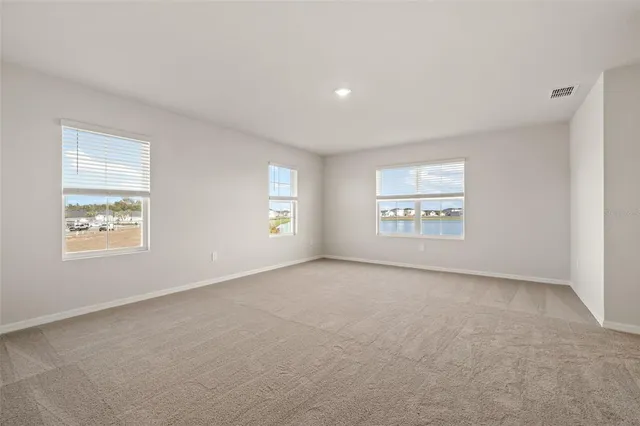 an empty room with windows and painted walls