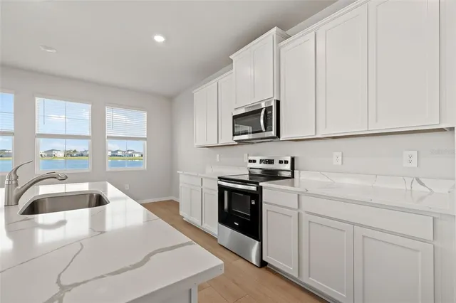 a kitchen with appliances and cabinets