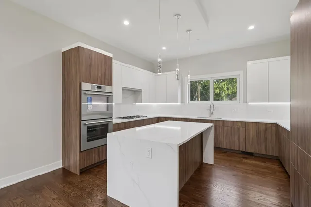 a kitchen with a sink stove and refrigerator