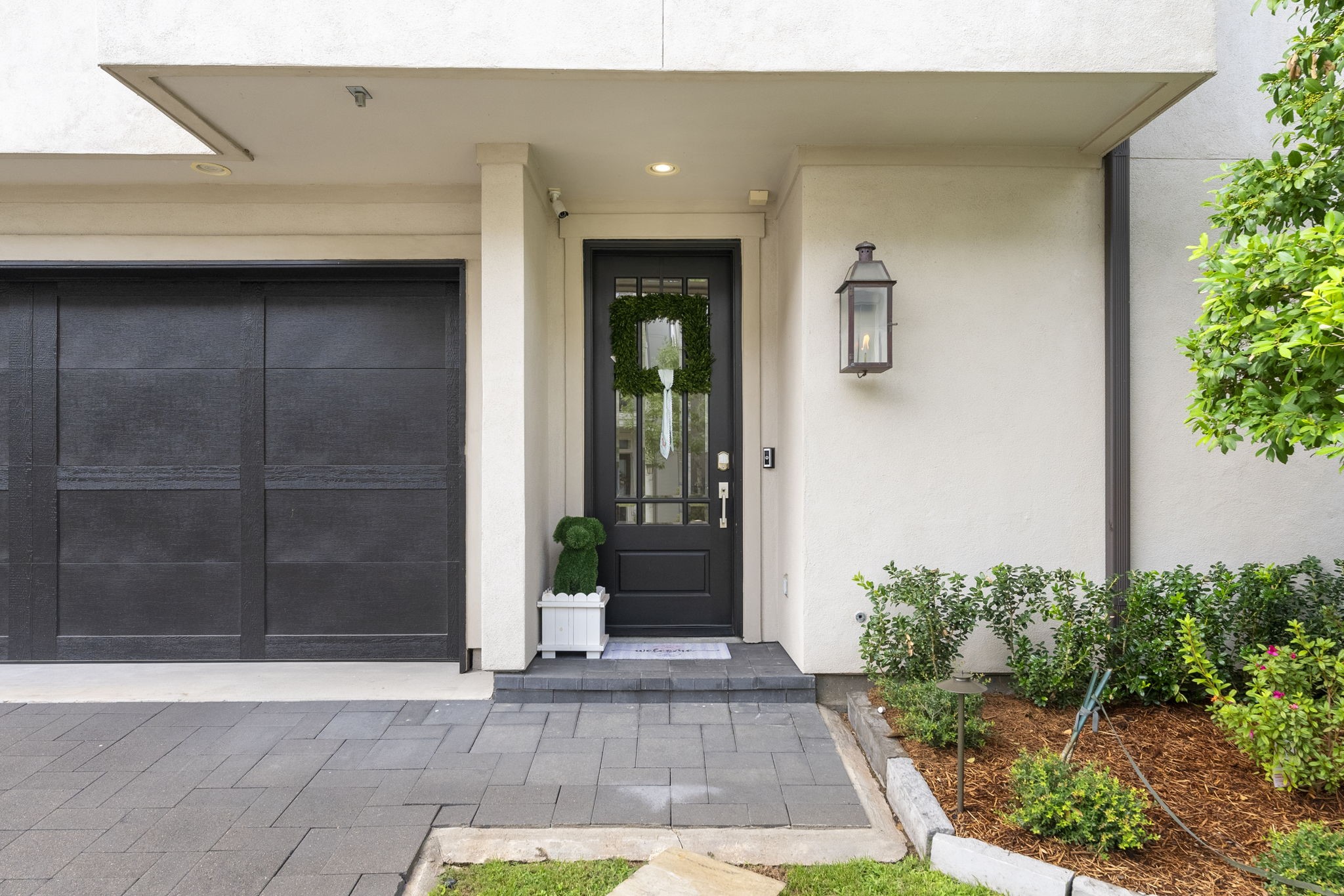 10 Nautical Terrace Way The Woodlands, TX 77380 - Photo 3 of 28 Welcoming covered entry with a glass-paneled front door, flickering copper gas lantern, keyless smart lock, video doorbell and security camera for added peace of mind, framed by landscape lighting and tidy plantings.