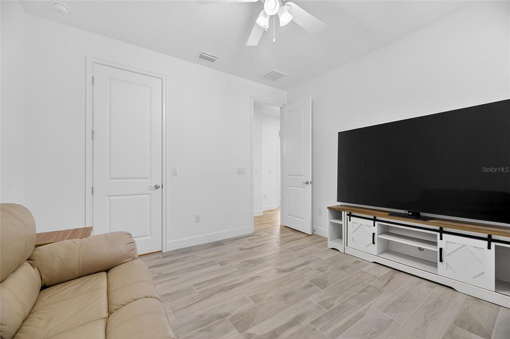 994 Signet Drive Apollo Beach, FL 33572 - Photo 48 of 98 a room with furniture and a flat screen tv