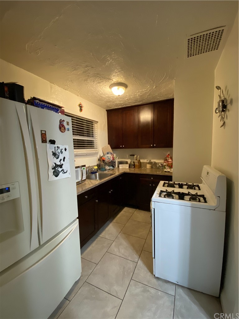 2467 California Street Huntington Park, CA 90255 - Photo 1 of 2 a kitchen with stainless steel appliances a refrigerator and a stove