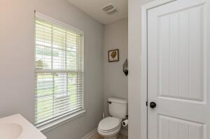 218 Wainwright Drive Crestview, FL 32539 - Photo 14 of 42 a bathroom with a toilet a sink and a window