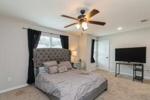 218 Wainwright Drive Crestview, FL 32539 - Photo 17 of 42 a bedroom with a bed and a flat tv screen on the dresser