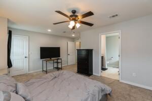 218 Wainwright Drive Crestview, FL 32539 - Photo 18 of 42 a bedroom with a bed and a flat screen tv