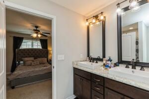 218 Wainwright Drive Crestview, FL 32539 - Photo 20 of 42 a en suite bathroom with a double vanity sink and a mirror
