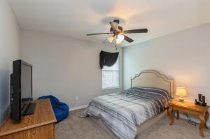 218 Wainwright Drive Crestview, FL 32539 - Photo 22 of 42 a bedroom with a bed and a chandelier