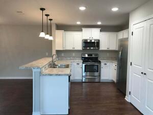 218 Wainwright Drive Crestview, FL 32539 - Photo 35 of 42 a kitchen with kitchen island white cabinets and stainless steel appliances