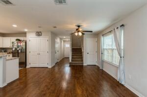 218 Wainwright Drive Crestview, FL 32539 - Photo 8 of 42 a view of a big room with wooden floor windows and chandelier