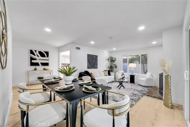 a dining room with furniture a rug and a painting