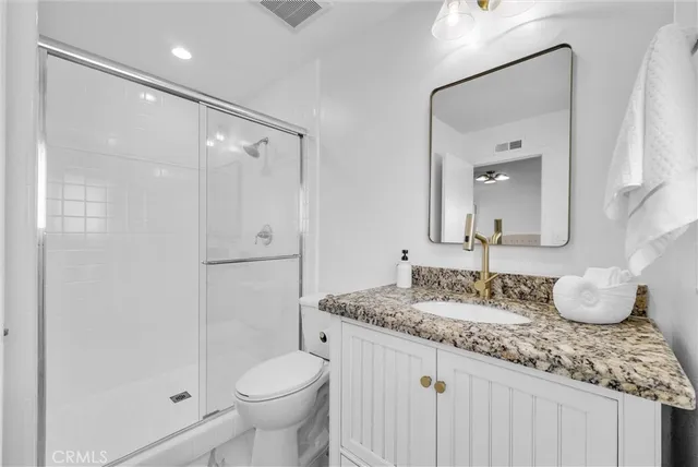 a bathroom with a double vanity sink mirror and bathtub