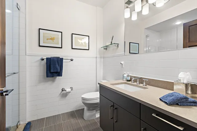 a bathroom with a sink a toilet and mirror