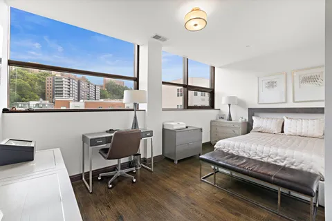 a bedroom with a bed window and a desk