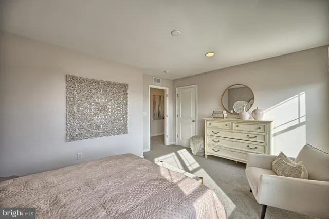 a bedroom with furniture and flowerpot