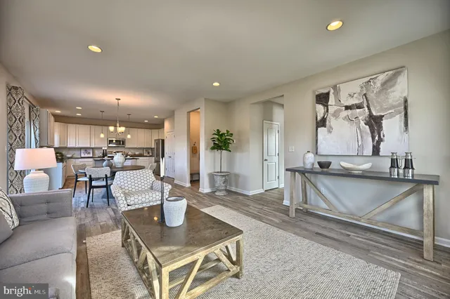 a living room with furniture and kitchen view