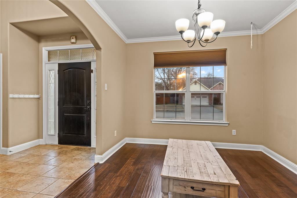 517 Austin Acre Road Sulphur Springs, TX 75482 - Photo 15 of 36 an empty room with wooden floor fan and windows