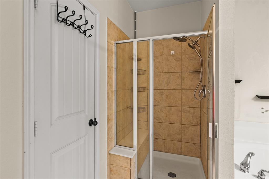 517 Austin Acre Road Sulphur Springs, TX 75482 - Photo 19 of 36 a bathroom with a glass shower door