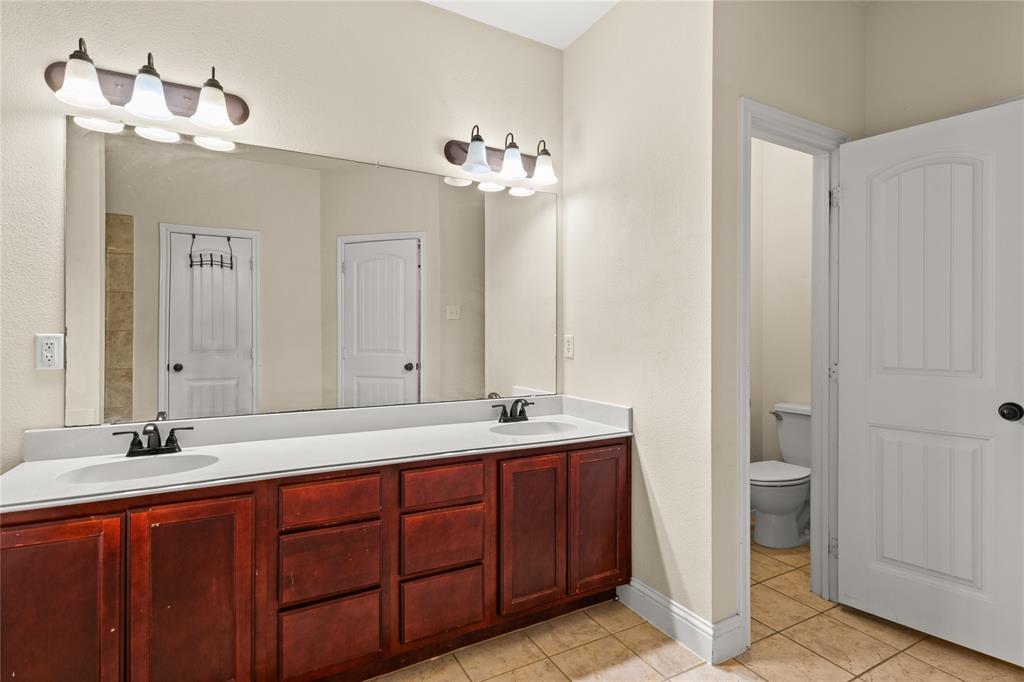 517 Austin Acre Road Sulphur Springs, TX 75482 - Photo 21 of 36 a bathroom with a double vanity sink and a mirror