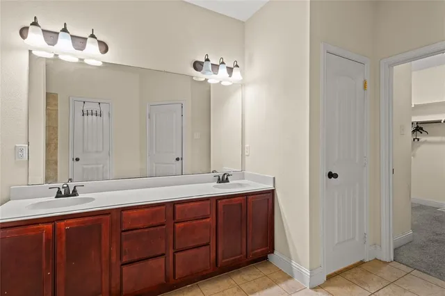 a bathroom with a double vanity sink and a mirror