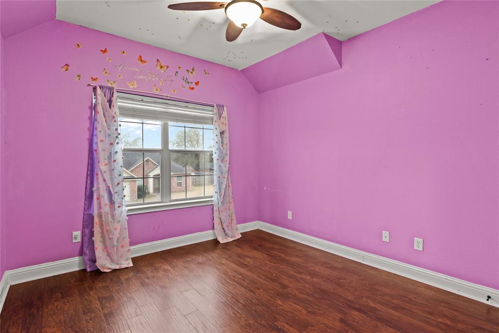 517 Austin Acre Road Sulphur Springs, TX 75482 - Photo 24 of 36 a view of a livingroom with wooden floor and a ceiling fan