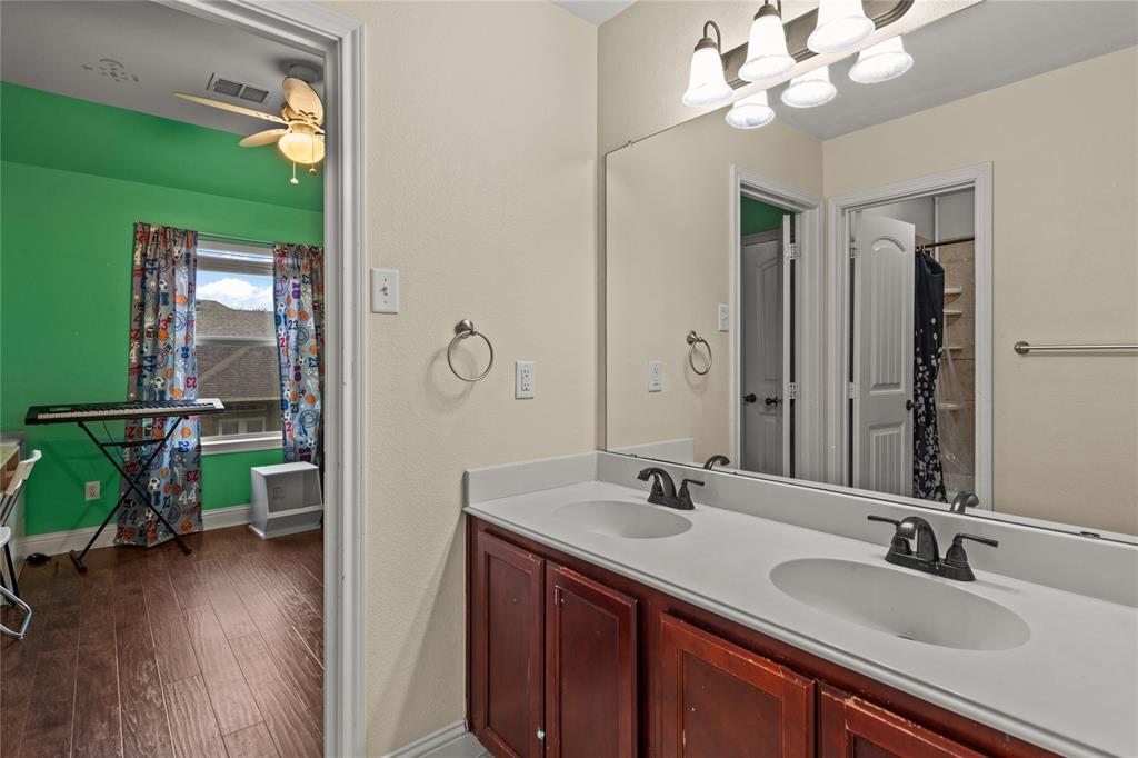517 Austin Acre Road Sulphur Springs, TX 75482 - Photo 26 of 36 a bathroom with a double vanity sink and a mirror
