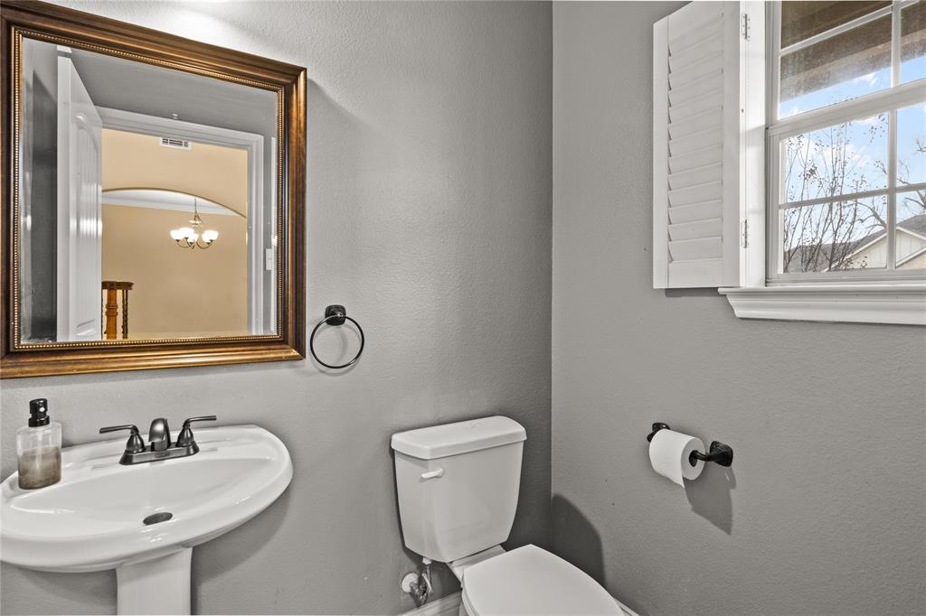 517 Austin Acre Road Sulphur Springs, TX 75482 - Photo 5 of 36 a bathroom with a toilet sink and mirror