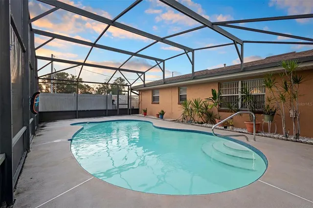 a view of a swimming pool with a yard