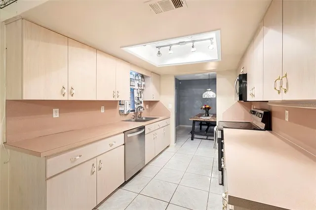 a kitchen with stainless steel appliances a refrigerator and a stove top oven