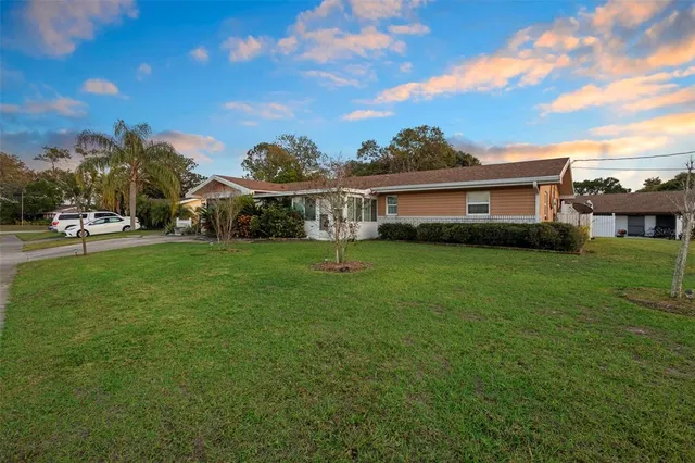 a view of a house with a backyard