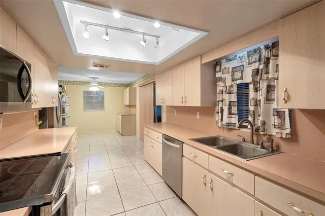 a kitchen with a sink cabinets and window