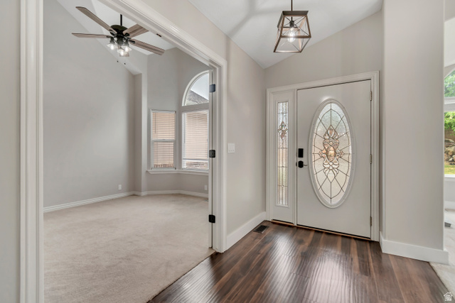 2154 Wasatch Boulevard Sandy, UT 84092 - Photo 5 of 55 Foyer featuring lofted ceiling, dark wood-style floors, ceiling fan, and dark colored carpet