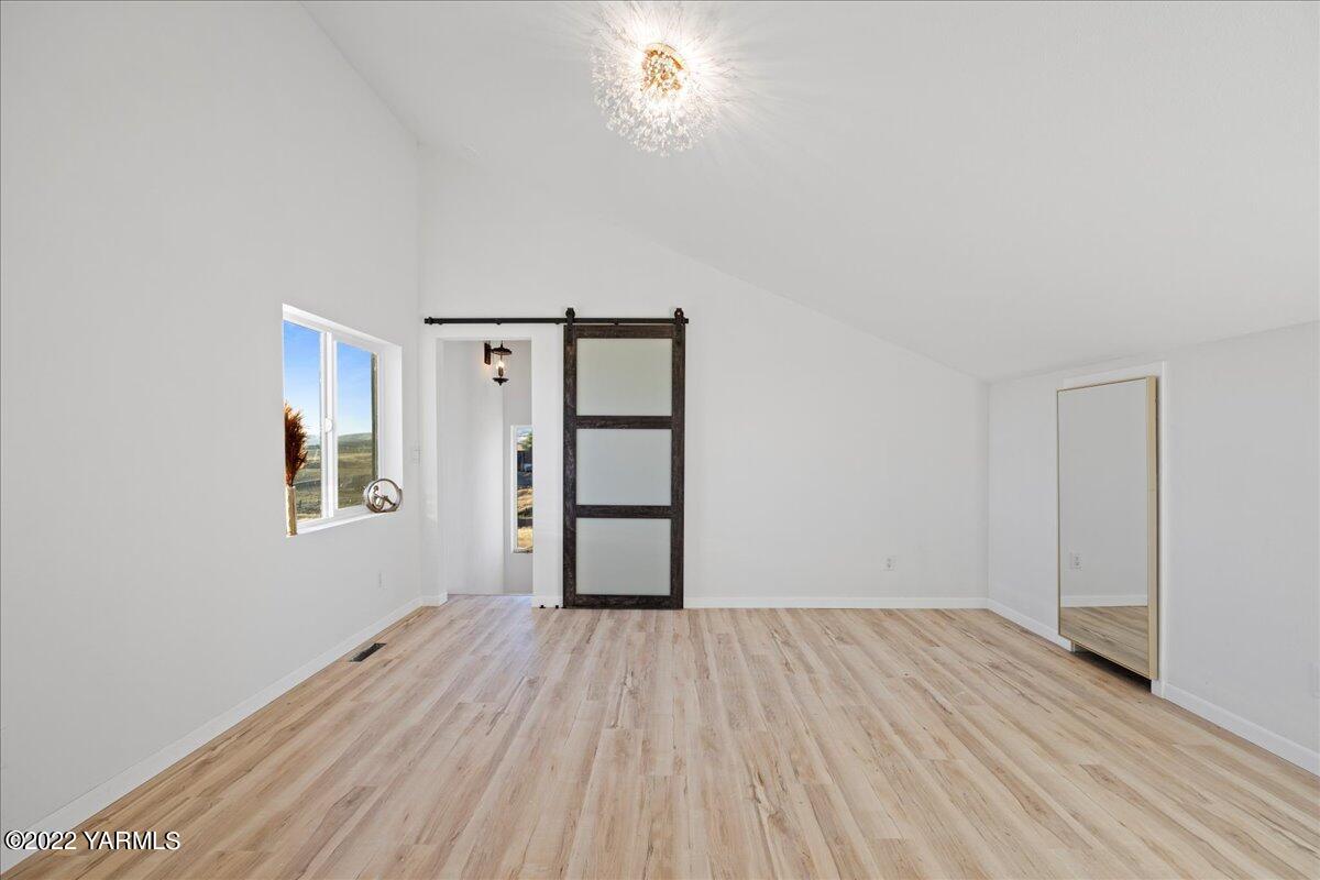 11211 Mieras Road Yakima, WA 98901 - Photo 29 of 40 wooden floor in an empty room with a window