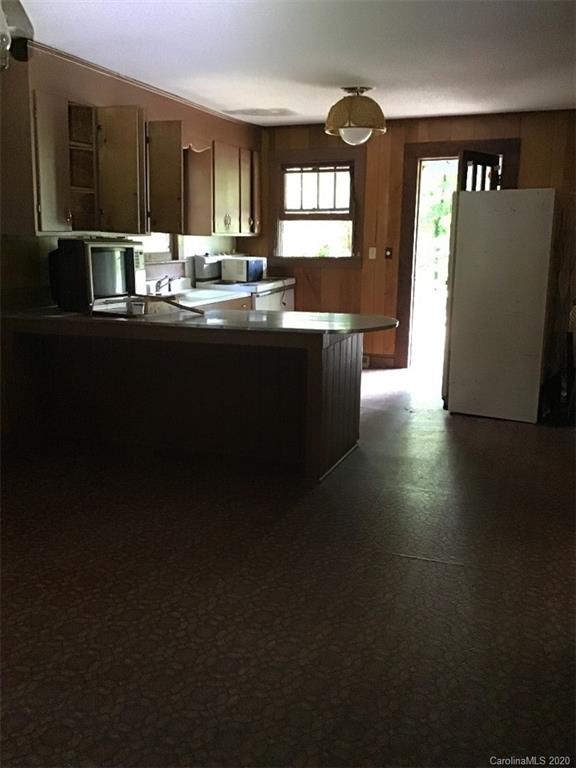 1030 Highway 64 Rutherfordton, NC 28139 - Photo 9 of 16 a kitchen with granite countertop a sink stove and cabinets