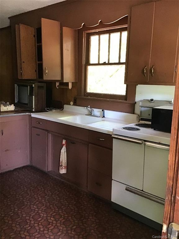 1030 Highway 64 Rutherfordton, NC 28139 - Photo 10 of 16 a kitchen with a sink cabinets and window