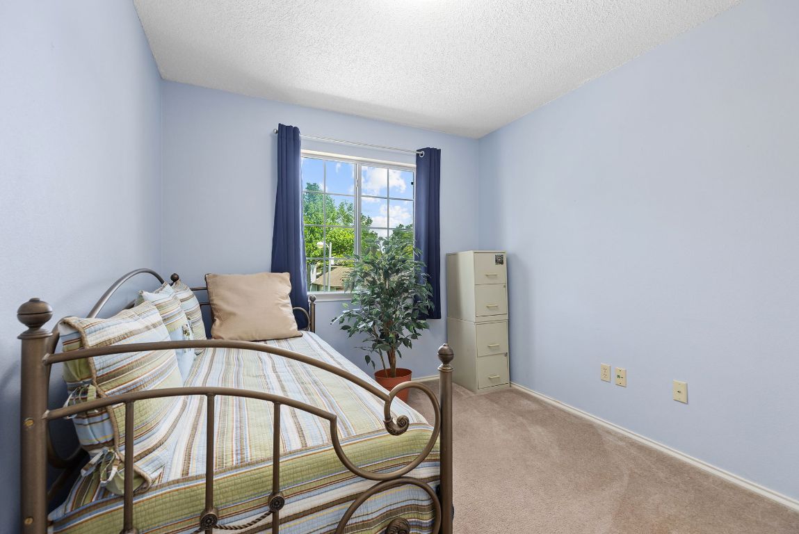 2158 Redwing Way Round Rock, TX 78664 - Photo 14 of 25 a bedroom with a bed and a potted plant