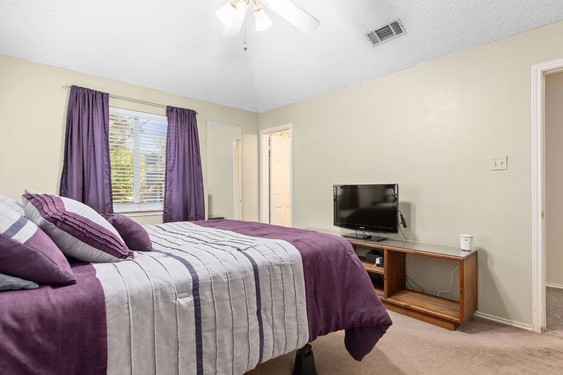2158 Redwing Way Round Rock, TX 78664 - Photo 19 of 25 a bedroom with a bed and a flat screen tv