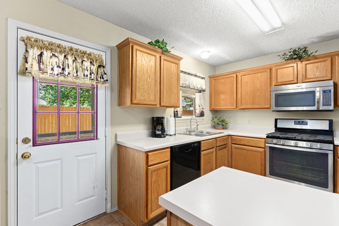 2158 Redwing Way Round Rock, TX 78664 - Photo 8 of 25 a kitchen with a sink stove and microwave