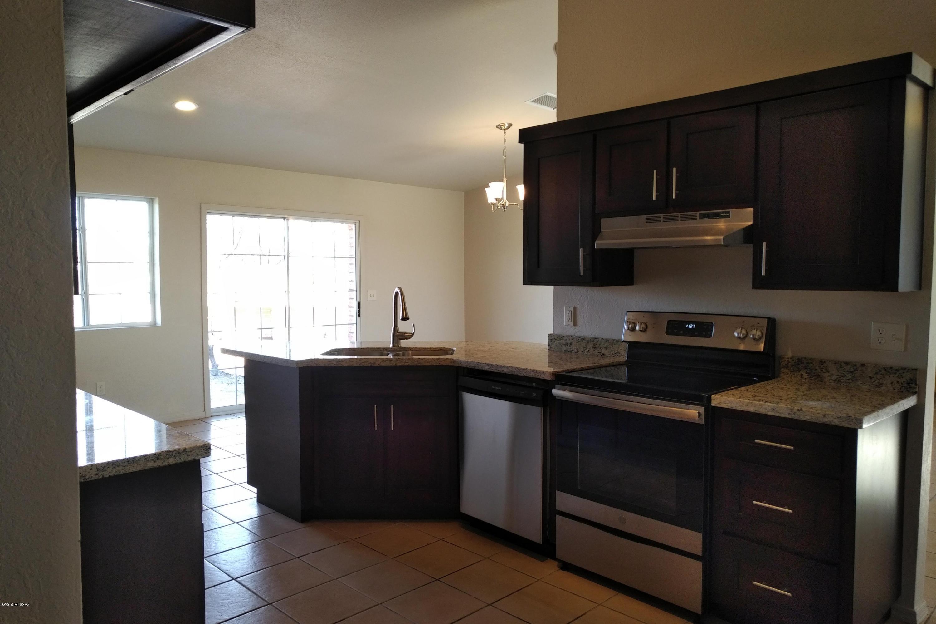 266 Mirto Court Rio Rico, AZ 85648 - Photo 14 of 22 a kitchen with a sink and a stove