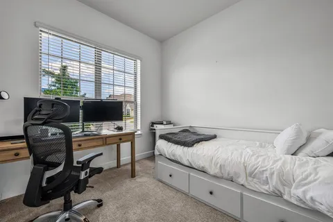 a bedroom with a workspace