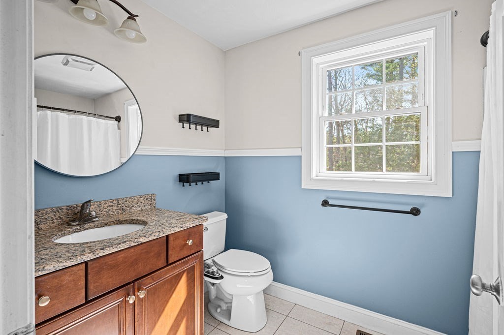 10 Caitlin Road Salisbury, MA 01952 - Photo 23 of 33 a bathroom with a granite countertop toilet sink mirror and vanity